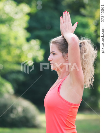 Woman Doing Yoga in the Park 57245861