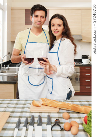 Couple cooking and drinking wine Couple cooking and drinking wine 57246710