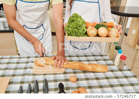 Couple cutting dish ingredients 57246717