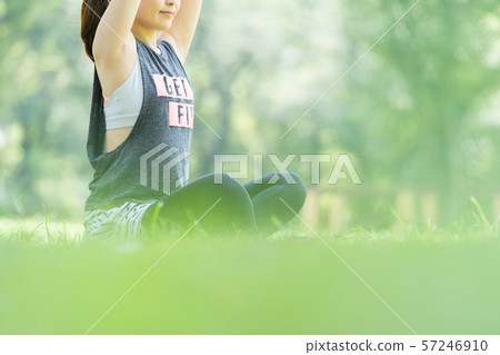 Woman doing yoga in the park 57246910