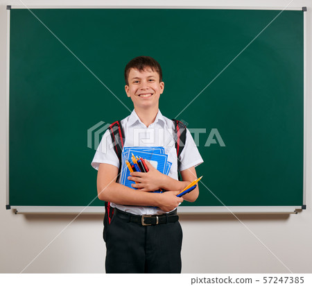 Portrait of a school boy posing with backpack and 57247385