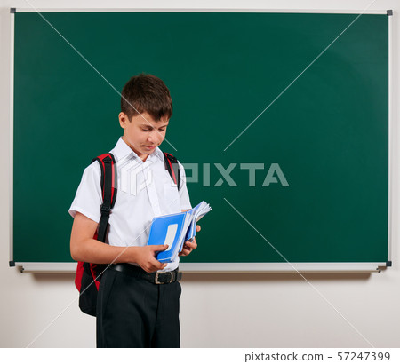 Portrait of a school boy posing with backpack and 57247399