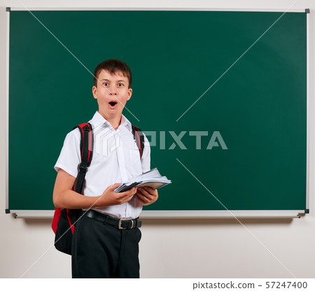 Portrait of a school boy posing with backpack and Portrait of a school boy posing with backpack and 57247400