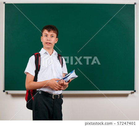 Portrait of a school boy posing with backpack and 57247401