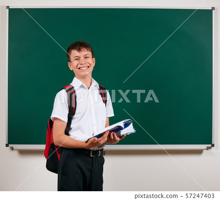 Portrait of a school boy posing with backpack and 57247403