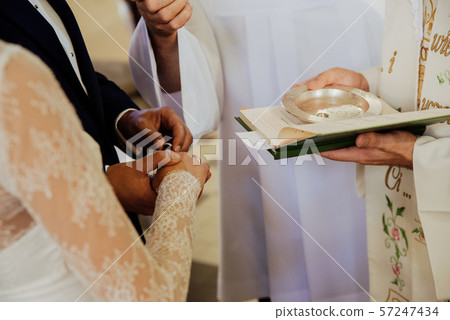 the young couple puts on rings during the wedding the young couple puts on rings during the wedding 57247434