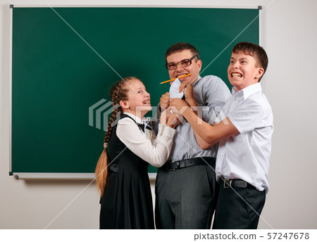 Portrait of a teacher checking homework, reading 57247678