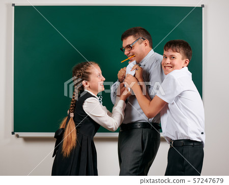 Portrait of a teacher checking homework, reading 57247679