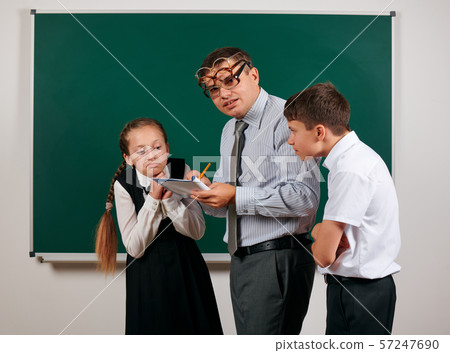 Portrait of a teacher checking homework, reading Portrait of a teacher checking homework, reading 57247690