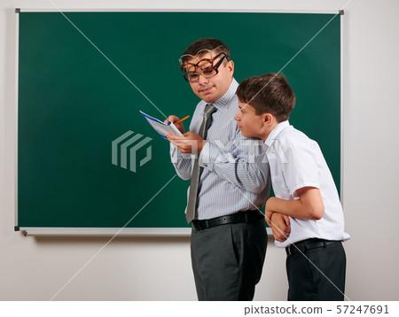 Portrait of a teacher checking homework, reading Portrait of a teacher checking homework, reading 57247691