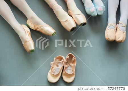 Legs of young ballerinas on grey background. 57247770