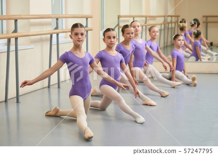Young ballerinas stretching on the floor. Young ballerinas stretching on the floor. 57247795