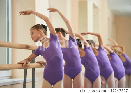 Tender ballerinas practicing at ballet class. 57247807