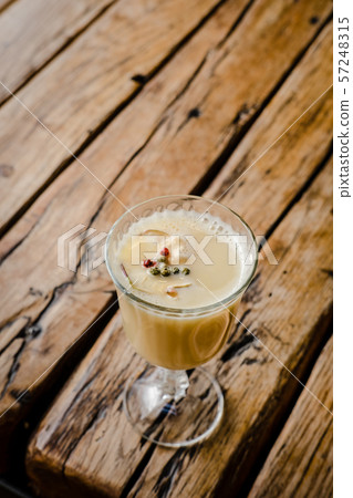 Fall hot punch cocktail on wooden table 57248315
