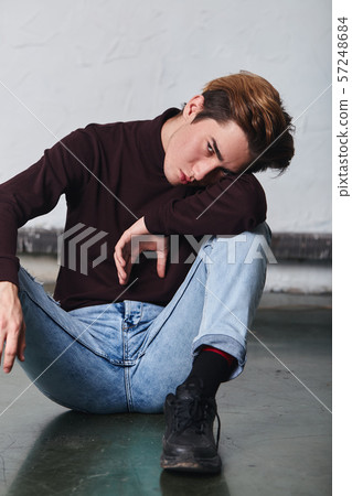 unhappy sad man leaning on his arm and looking at the camera 57248684