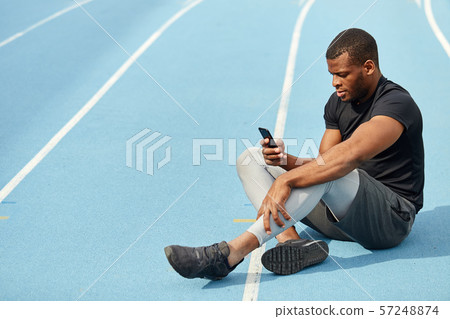handsome athlete having a break during training handsome athlete having a break during training 57248874