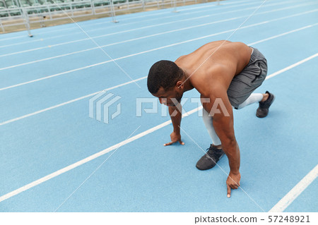 sporty ambitious guy doing exercises for legs 57248921