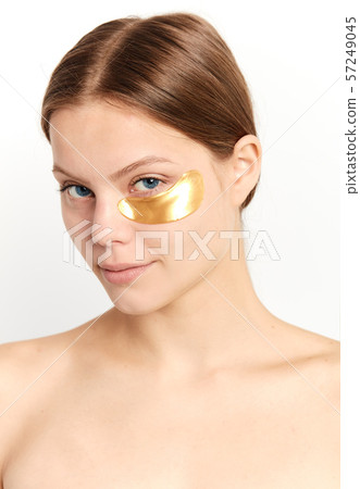 young beautiful cheerful girl experimenting with a patch under eyes 57249045