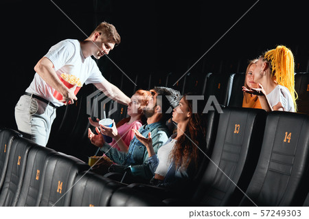 drunk man holding popcorn and flirting with ginger girl 57249303