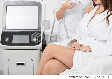 woman with crossed legs sitting in the beauty salon and waiting for procedure 57249331