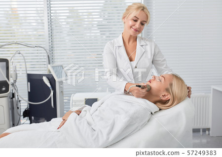 blonde girl enjoying peeling of skin 57249383