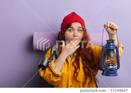 tired ginger plump hiker with freckles closing her mouth with a plm, yawning tired ginger plump hiker with freckles closing her mouth with a plm, yawning 57249647