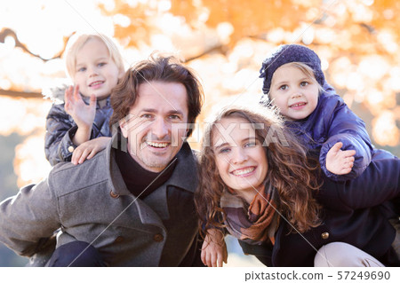 Family hug in autumn park Family hug in autumn park 57249690