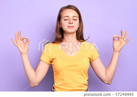Young beautiful female yoga instructor with peaceful face expression 57249995