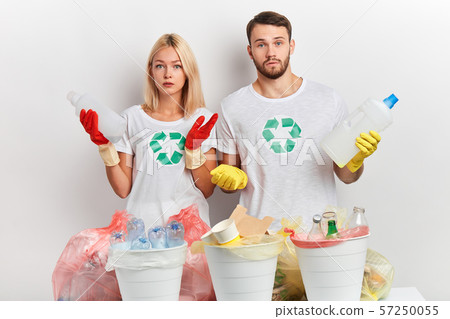 young puzzled emotional couple doesn't know what to do with litter 57250055
