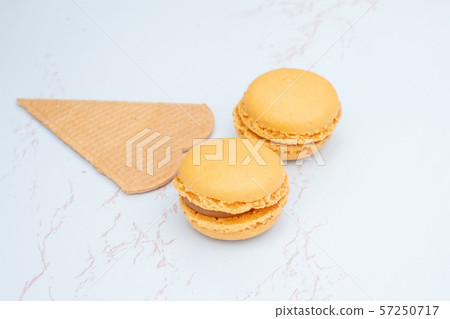 Fun flat lay composition of macarons and a cookie Fun flat lay composition of macarons and a cookie 57250717