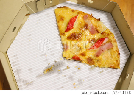 Leftover pizza in box. 57253138