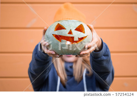 Woman holding Halloween pumpkin 57254124
