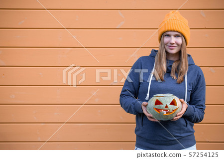 Woman holding Halloween pumpkin 57254125