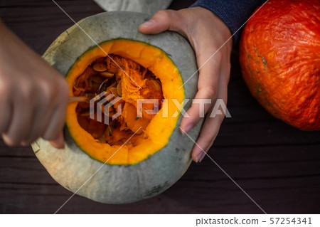 Hollowing out a pumpkin Hollowing out a pumpkin 57254341