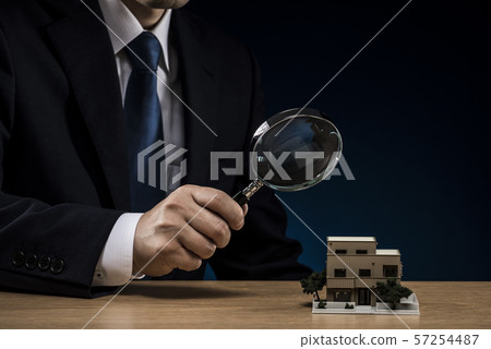 Businessman loupe house model 57254487