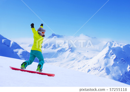 Snowboarder running down slope Snowboarder running down slope 57255118