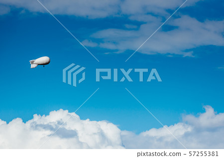 White airship with camera floating in sky 57255381