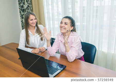 Happy business girl laughing at the Desk. Laughing 57256549