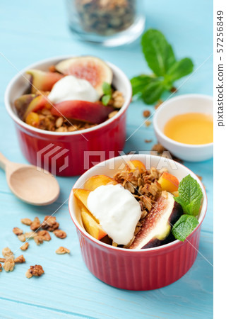 Fig and peach crisp served with cream Fig and peach crisp served with cream 57256849