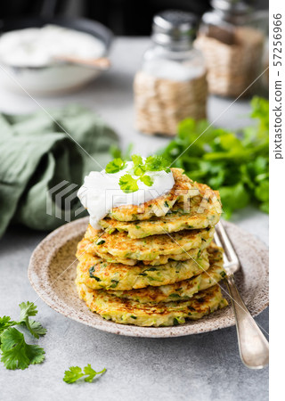 Zucchini quinoa fritters with sour cream 57256966