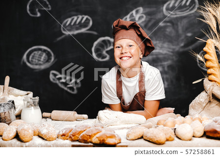 cute boy with chef hat cooking 57258861