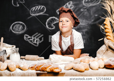 cute boy with chef hat cooking 57258862