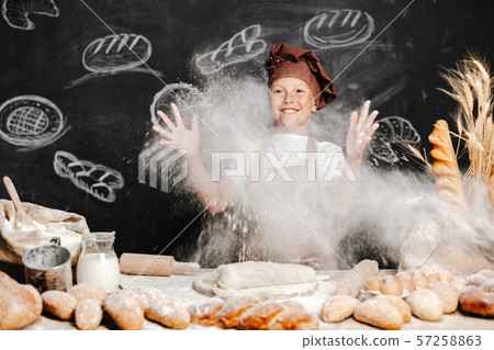 cute boy with chef hat cooking 57258863