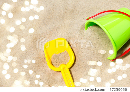 close up of toy bucket and shovel on beach sand 57259066