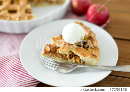 piece of apple pie with ice cream on plate piece of apple pie with ice cream on plate 57259168