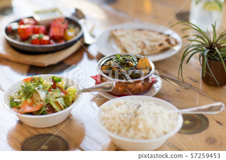 close up of aloo palak dish in bowl on table 57259453