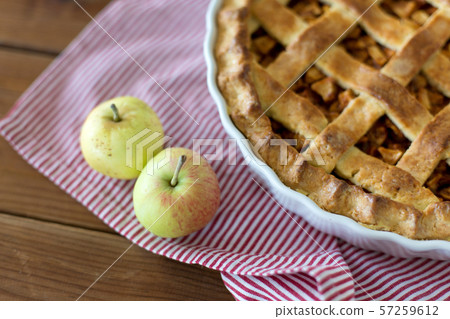 apple pie in baking mold on wooden table apple pie in baking mold on wooden table 57259612