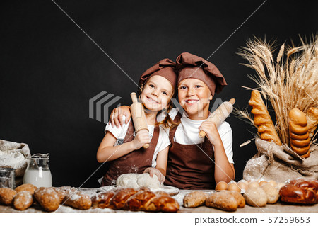 Adorable girl with brother cooking 57259653