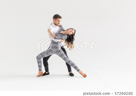 Passionate couple dancing social danse kizomba or bachata or semba or taraxia on white background 57260280