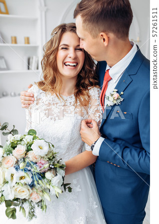 Beautiful bride in white dress and groom in suit, 57261511